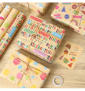Flat lay of Happy Birthday kraft wrapping paper set with colorful stickers and jute twine