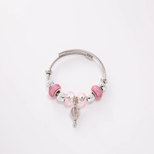 Detail of silver twisted wire bracelet with pink beads and hot air balloon charm