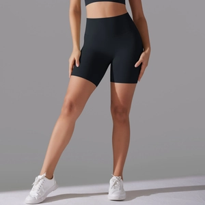 Detail of high-waisted black yoga shorts with seamless front and compression fit