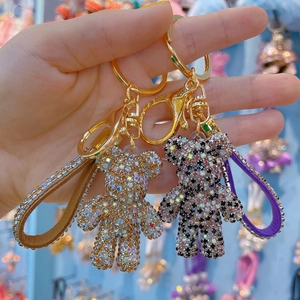 Sparkling crystal bear keychain with studded leather strap and gold ring for women