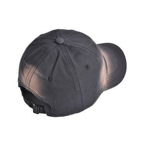 Detail view of cotton baseball cap with vintage reddish-brown tie-dye wash and metal buckle