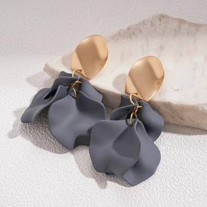 Detail view of acrylic flower earrings with gold metal top and dark grey matte petals