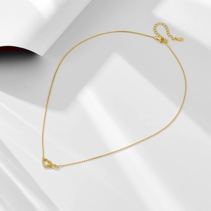 Close-up of golden S925 silver necklace with heart and infinity symbol pendant