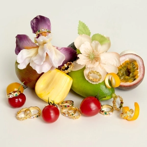 Luxury gold-plated stainless steel rings set with colorful zircon on fresh fruit background