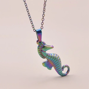 Macro shot of a rainbow-colored seahorse pendant on a polished metal necklace chain