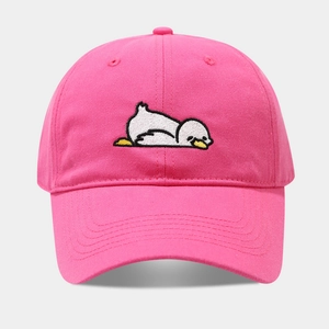 Close-up of cute white cartoon duck embroidery on a bright pink cotton baseball cap