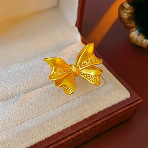 Golden bow butterfly open ring with intricate filigree and brushed finish details