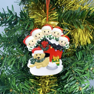 Detailed resin Christmas dog house ornament featuring 5 family members and a golden retriever