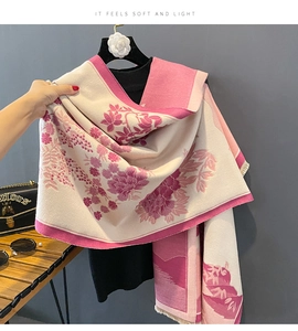 Detail of floral cashmere-like scarf with landscape pattern and soft tassel edges