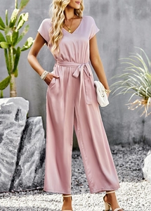 Detailed view of pink V-neck wide leg jumpsuit with waist belt for casual elegant look