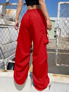 Street style view of women's red cargo pants with elastic high waist and side pockets