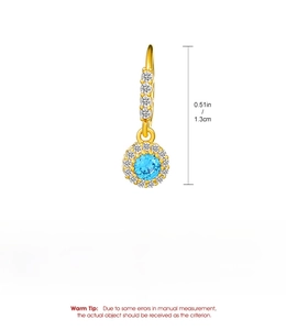 Detail of gold dangle earring featuring sky blue round stone and white zircon inlays