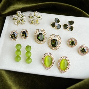 Detailed view of olive green zircon flower earrings with metal base and crystal inlay