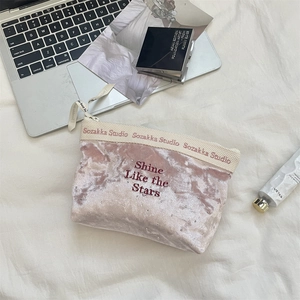 Detail of pink velvet makeup bag with Shine Like the Stars embroidery and crystal accents