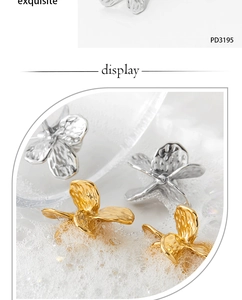 Macro view of gold and silver flower petal earrings with textured hammer finish