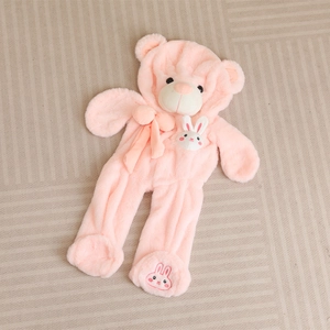 Pink teddy bear baby romper with rabbit patches and 3D ears on a soft plush texture