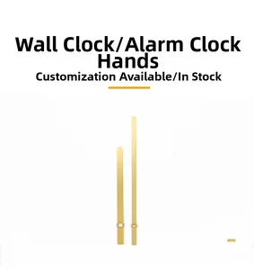 Close-up of golden metal wall clock hands with brushed texture and circular mounting holes