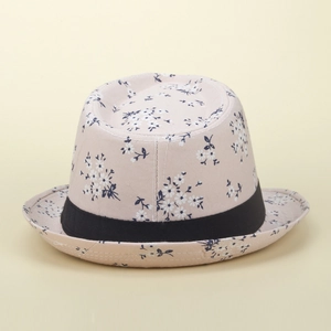 Detail of floral print straw sun hat with black ribbon and delicate daisy pattern