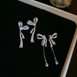 Sparkling zircon bow earrings with silver needles and long tassel drop pendants