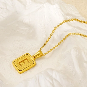 Golden stainless steel necklace with frosted rectangular letter E pendant on O-chain