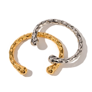 Minimalist 18K gold and silver stainless steel bangles with artistic lava hammered texture
