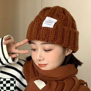 Caramel knitted beanie hat and scarf set for winter fashion with woven texture