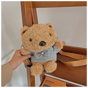Detail of cute plush teddy bear bag with grey sweater and adjustable fabric strap