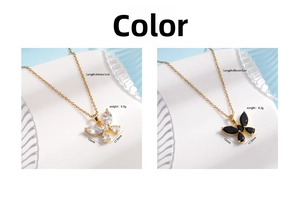 Detailed views of gold butterfly necklaces with black and white cubic zirconia pendants