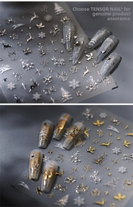 Detail of 3D metallic Christmas nail stickers featuring silver deer and snowflake patterns