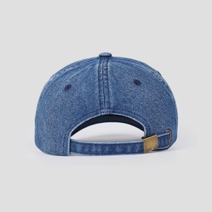 Detail of blue denim baseball cap back featuring a vintage bronze metal adjustment buckle