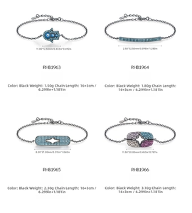 Detailed view of four black S925 silver bracelets with hamsa, stars and turquoise pendants
