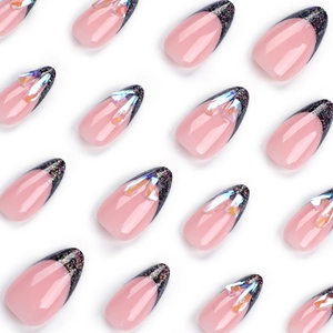 Pink almond press-on nails with black glitter French tips and iridescent rhinestones
