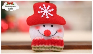 Detailed close-up of a plush snowman doll with a red embroidered hat and green bow tie