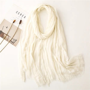 Elegant cream white pleated scarf with fringe edge on a minimalist aesthetic background
