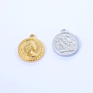 Detailed view of vintage gold Queen Elizabeth II and silver St. George coin pendants