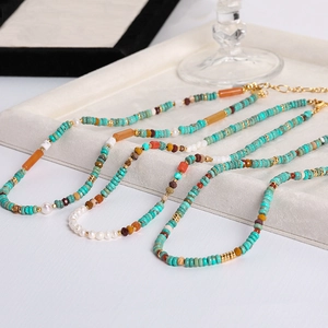 Handmade turquoise and pearl beaded necklace set with gold clasps in bohemian style