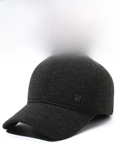Detailed view of dark grey textured wool baseball cap with side metal shield badge