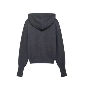 Detail view of the back of a dark gray hooded sweater with knitted rib knit texture