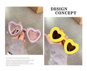 Detail showing purple metallic and yellow heart-shaped sunglasses with stylish resin frames