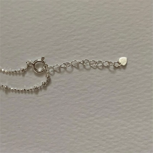 Close-up of S925 sterling silver beaded bracelet showing spring clasp and 925 heart tag
