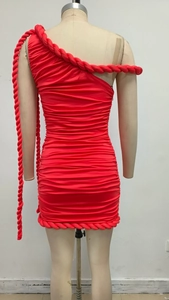 Detail of red one-shoulder mini dress with braided rope trim and pleated fabric texture