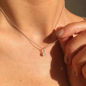 Classic silver necklace featuring a round sparkling cubic zirconia pendant on model