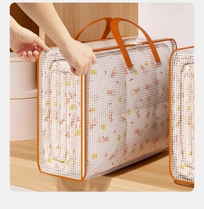 Detail of white mesh storage bag with orange reinforced handles for quilt packing