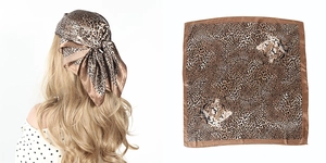 Detail view of leopard print square scarf showing hair styling and flat lay pattern