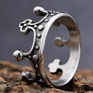 Macro side view of vintage silver crown ring with intricate punk metal engraving details