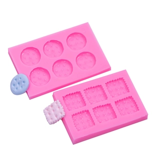 Pink silicone molds for heart and star cookies with detailed fondant samples