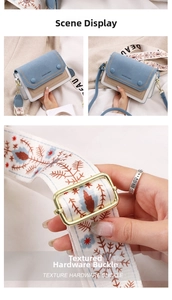 Detail of crossbody bag featuring embroidered ethnic strap and premium gold hardware buckle