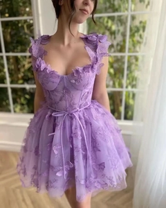 Detailed view of 3D butterfly appliqués and floral embroidery on purple tulle party dress