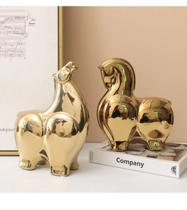 Close-up of golden abstract horse statues with polished mirror finish for home decor