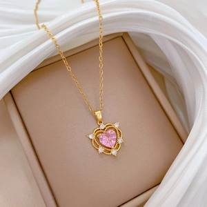 Luxurious gold heart necklace with pink gemstone in jewelry box with white silk